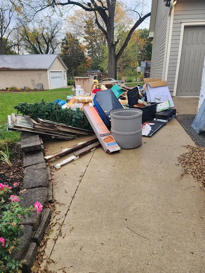 Dumpster being loaded with debris for 12 Yard Dumpster Rental in Sachse
